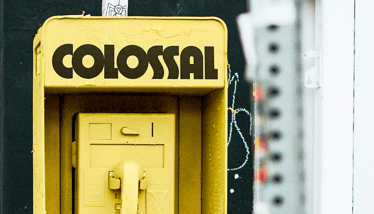 Colossal, art by humans for humans, printed on newsprint resting on a bench